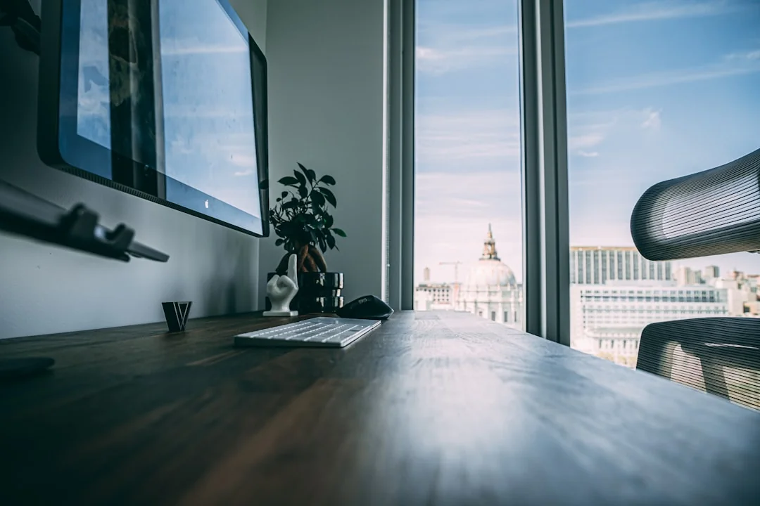 A stylish workspace featuring a laptop and monitors displaying design software.